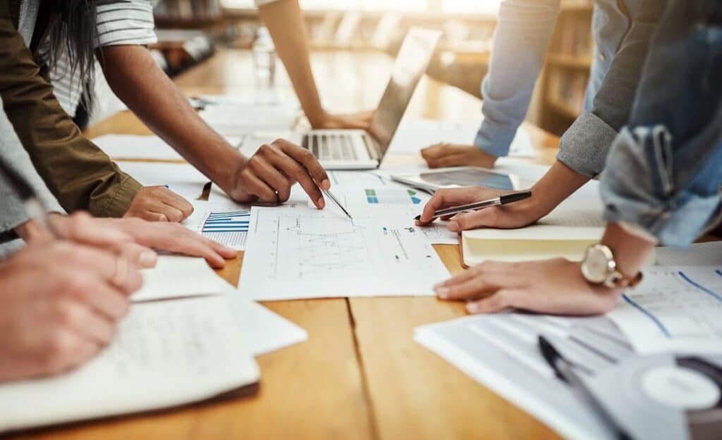 A group of business people engaged in paperwork at a table