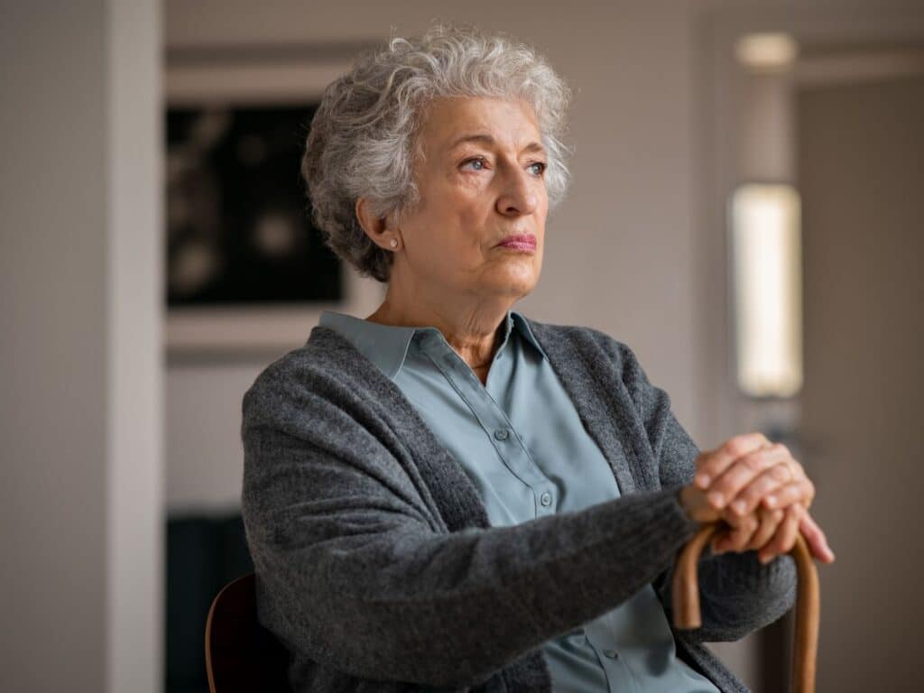 A senior woman sitting comfortably in a chair